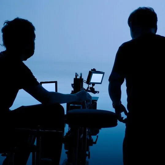 About Us 1 video produciton worker in black blue sky